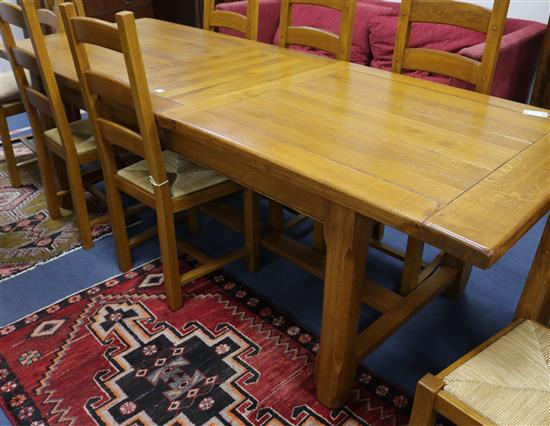 An oak dining table L.286cm